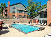 Thumbnail 3 of 26 - A swimming pool surrounded by lounge chairs and umbrellas.