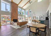 Thumbnail 25 of 26 - A modern dining room with a wooden table and chairs.