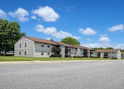 Thumbnail 3 of 4 - A row of houses with a clear blue sky above them.