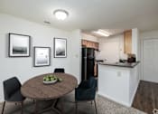 Thumbnail 3 of 20 - A dining room with a table and chairs.