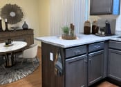 Thumbnail 11 of 12 - a kitchen with an island and a dining room with a table