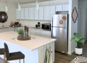 Thumbnail 61 of 65 - a kitchen with a white counter top and a stainless steel refrigerator