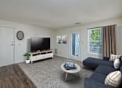 Thumbnail 2 of 20 - A living room with a flat screen TV and a sofa.