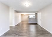 Thumbnail 36 of 43 - A spacious room with wooden flooring and white walls.