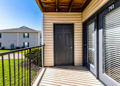 Thumbnail 41 of 43 - A black door is on the right side of a house.