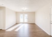 Thumbnail 39 of 43 - A room with wooden floors and white walls.