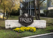 Thumbnail 1 of 20 - a sign for the trails in front of a building