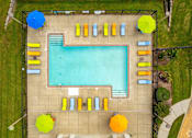 Thumbnail 8 of 35 - An aerial view of a swimming pool surrounded by sun loungers and umbrellas.