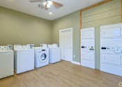 Thumbnail 9 of 23 - A laundry room with a washer and dryer in it.