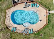 Thumbnail 7 of 23 - An aerial view of a swimming pool surrounded by a fence and lounge chairs.