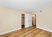 Thumbnail 16 of 21 - A room with a white door and a white cabinet.