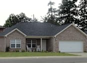 Thumbnail 2 of 7 - a house with a lawn and a white garage door