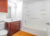 Thumbnail 15 of 25 - A white toilet sits next to a sink in a bathroom.