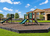 Thumbnail 56 of 61 - A playground with a green slide and a red and green slide.