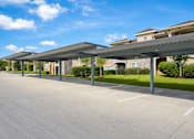 Thumbnail 55 of 61 - A parking lot with a building in the background.