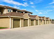 Thumbnail 54 of 61 - A row of houses with garages in front.