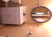 Thumbnail 13 of 21 - A bathroom with a toilet, sink and mirror.