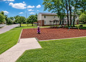 Thumbnail 4 of 4 - A playground with a red surface and a purple slide.