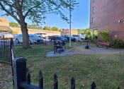 Thumbnail 13 of 14 - a small yard in front of a building with a picnic table