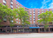 Thumbnail 14 of 14 - a large brick building with trees in front of it