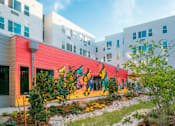 Thumbnail 11 of 22 - A colorful mural on a building's side.