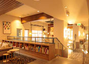 Thumbnail 19 of 22 - A room with a wooden bookshelf and a glass railing.