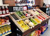 Thumbnail 8 of 8 - A fruit stand with a variety of fruits and juices.