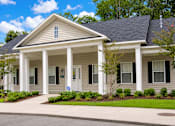 Thumbnail 1 of 3 - A house with a front porch and a driveway.