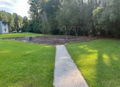 Thumbnail 3 of 3 - a path leading to a swing set in a park