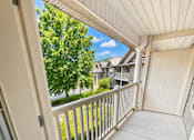 Thumbnail 12 of 12 - A white door opens to a balcony with a white railing.