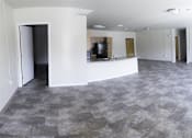 Thumbnail 12 of 39 - A large empty room with a checkered floor and white walls.