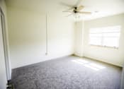 Thumbnail 1 of 39 - A room with a ceiling fan and a window.