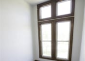Thumbnail 22 of 39 - A stairway with a window above it.