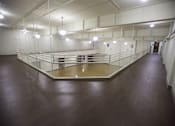 Thumbnail 25 of 39 - A large room with wooden floors and a glass partition in the middle.