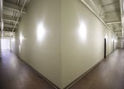 Thumbnail 30 of 39 - A long hallway with a light on the wall.