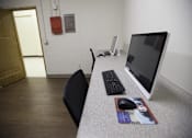 Thumbnail 39 of 39 - A black chair sits in front of a desk with a keyboard and mouse on it.
