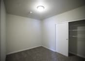 Thumbnail 5 of 39 - A room with a white door and a light on the ceiling.