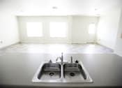 Thumbnail 7 of 39 - A kitchen with a double sink and a window.