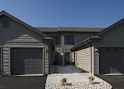 Thumbnail 2 of 12 - A house with two garages and a driveway.