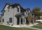 Thumbnail 5 of 12 - A modern house with a grey exterior and a black gate.