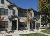 Thumbnail 4 of 12 - A modern house with a grey facade and a black gate.