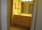 Thumbnail 12 of 12 - A bathroom with a sink and a mirror.