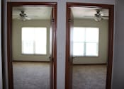 Thumbnail 12 of 17 - Two rooms with carpet floors and ceiling fans.