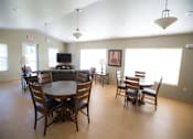 Thumbnail 6 of 21 - A large room with a table and chairs.