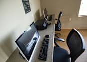 Thumbnail 7 of 13 - A black computer mouse and keyboard are on a desk with a laptop.
