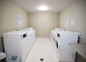 Thumbnail 9 of 13 - A laundromat with washers and dryers.