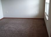Thumbnail 11 of 15 - A room with a brown carpet and white walls.