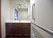 Thumbnail 8 of 15 - A bathroom with a sink and a mirror.