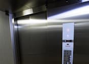 Thumbnail 2 of 21 - A silver elevator with a control panel and a lit up red light.