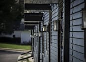 Thumbnail 12 of 21 - A row of black lampposts line a sidewalk.